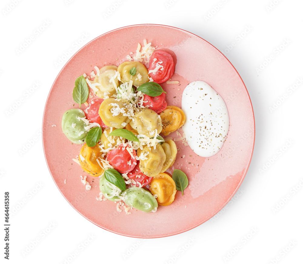 Plate of boiled colorful dumplings with cheese, basil and sour cream isolated on white background