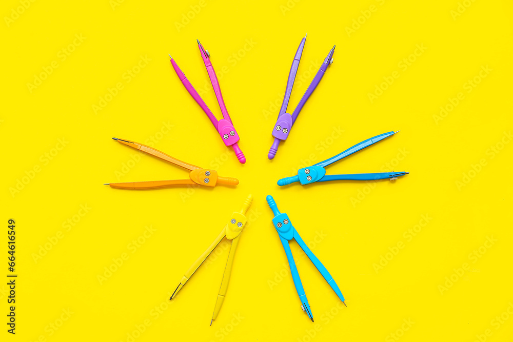 Composition with different compasses on yellow background