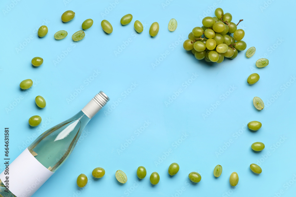 Frame made of bottle with tasty wine and grape on blue background