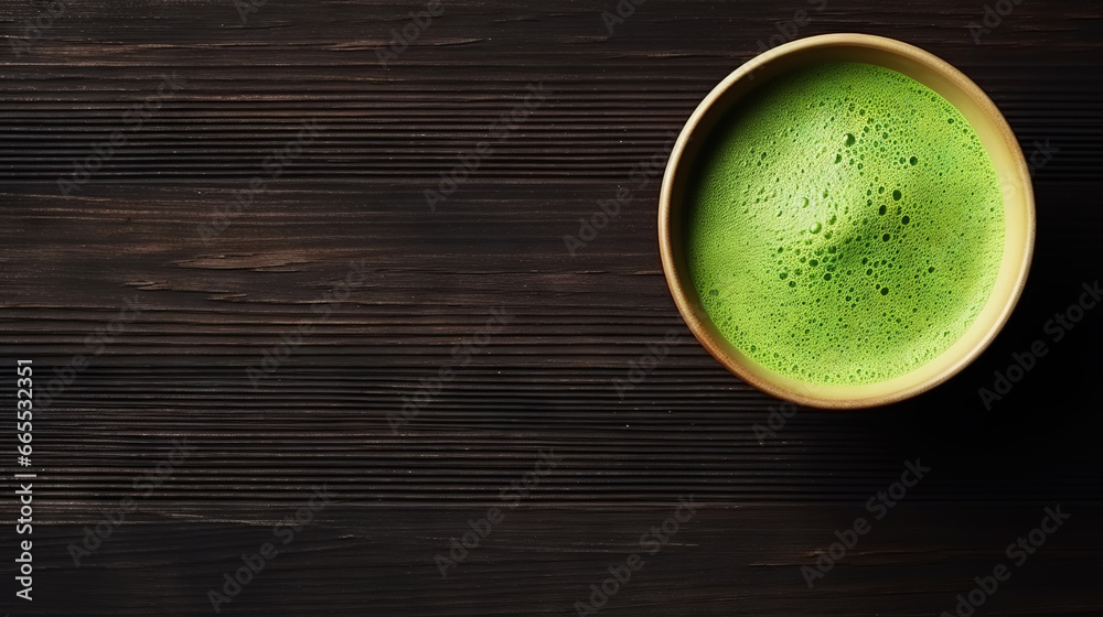 Matcha tea powder in a wooden plate on dark background with whisk, top view, copy space. Generative AI