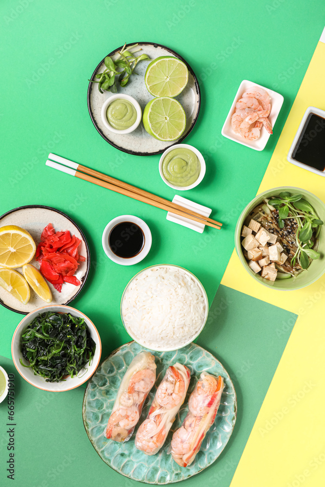 Composition with delicious Chinese dishes and chopsticks on color background