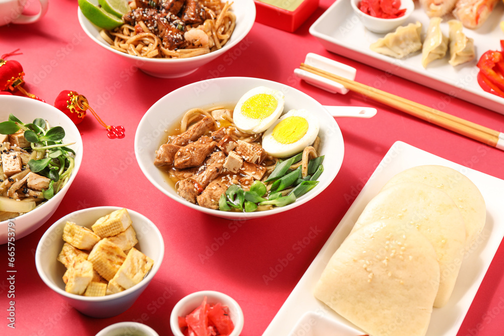 Composition with different Chinese food on red background