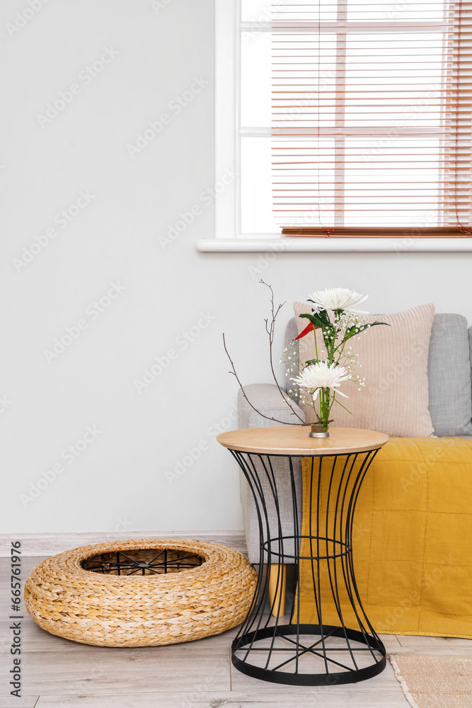 Beautiful ikebana on table in living room