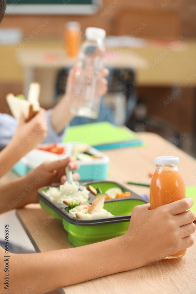 Little boy eating lunch in classroom, closeup