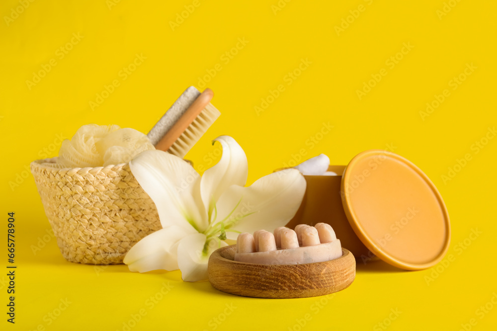 Composition with spa supplies and beautiful lily flower on yellow background