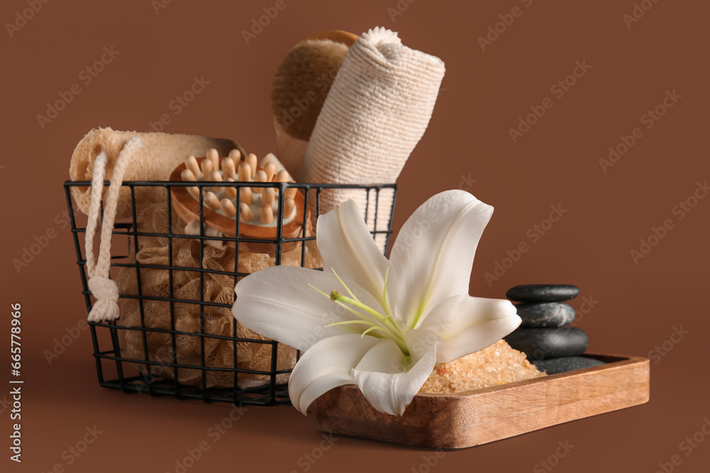 Set of different spa accessories and beautiful lily flower on color background