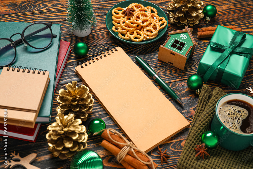 Beautiful Christmas composition with blank notebooks, cup of coffee and decor on wooden background