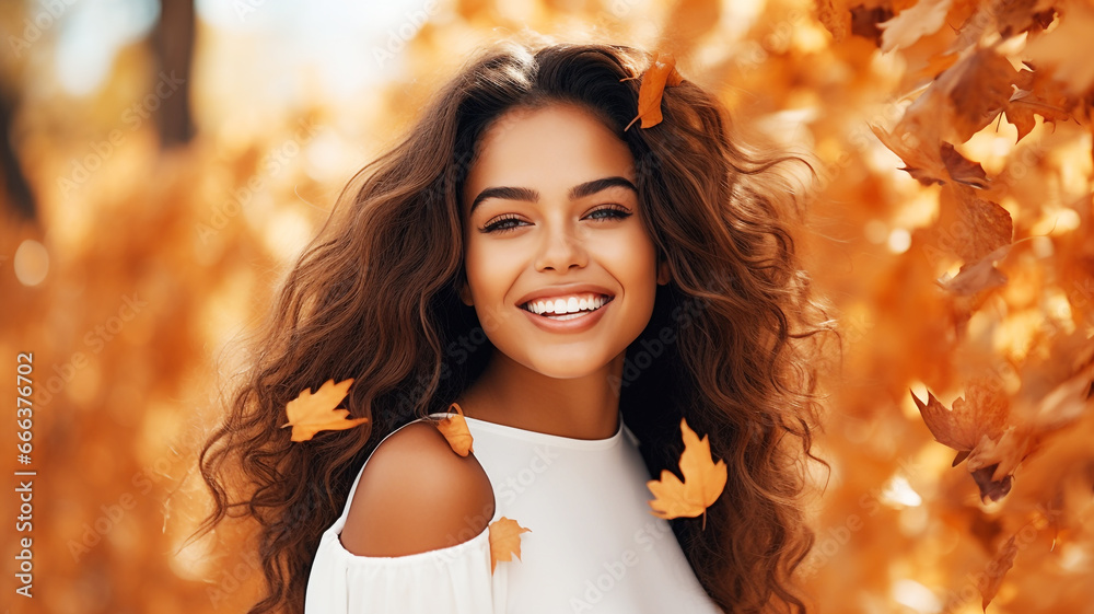 Beautiful young hispanic woman with autumn leaves