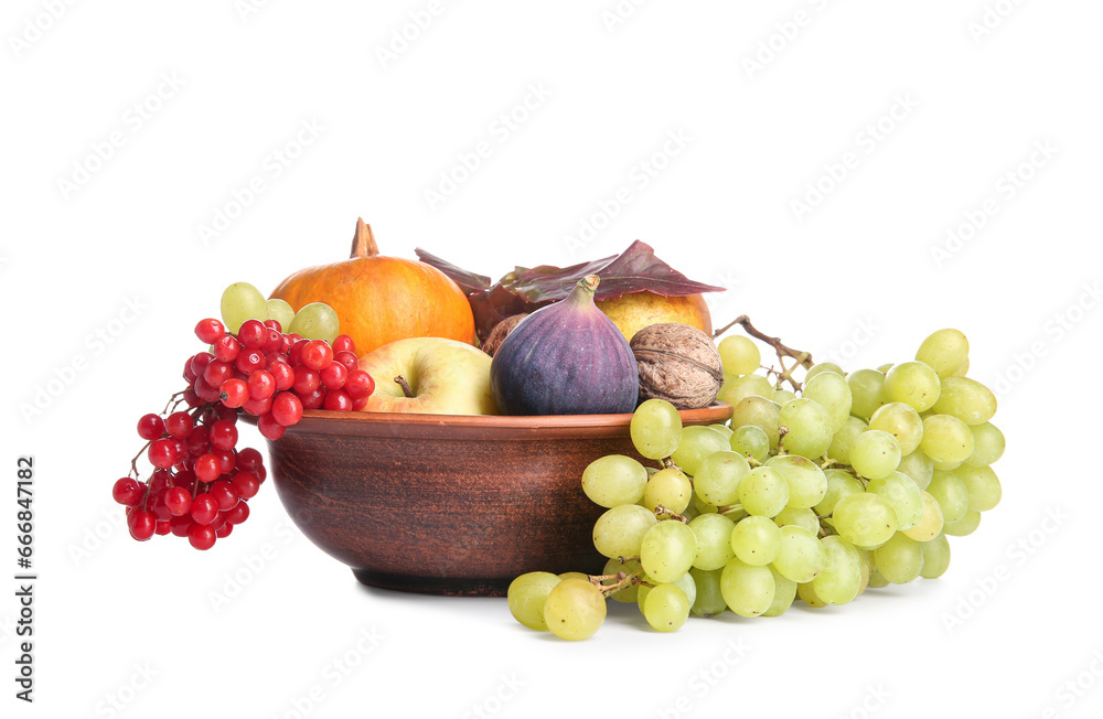 Bowl with different fresh fruits, pumpkin and berries on white background