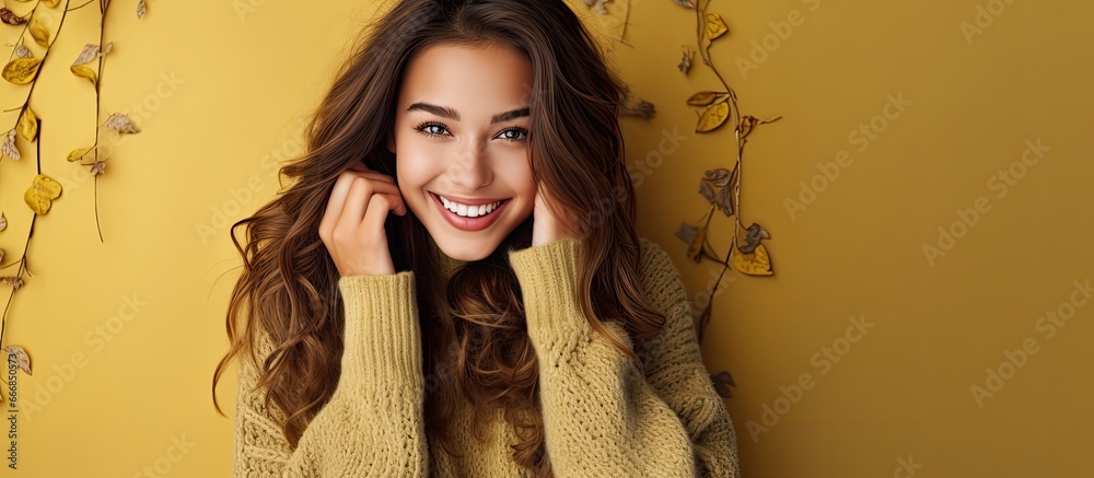 Stunning young woman in sweater and gloves embodies fall and winter fashion