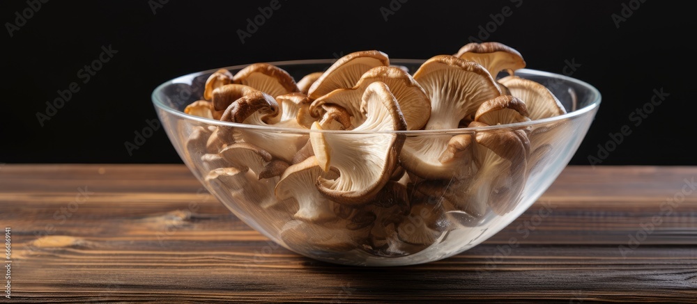 Asian Cuisine ingredient Kikurage mushrooms and wood ears in a transparent bowl on a gray wooden table Copyspace