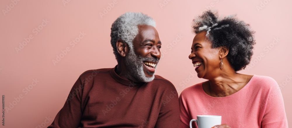 Elderly African couple enjoying coffee at home