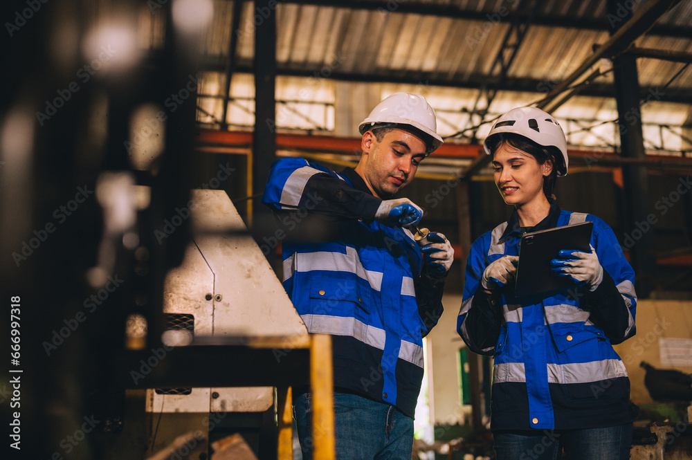 Testing innovative new automatic turning tools for smart industries professional robot engineer Expert in maintaining and controlling robot arms in factory warehouses. Technicians work together 