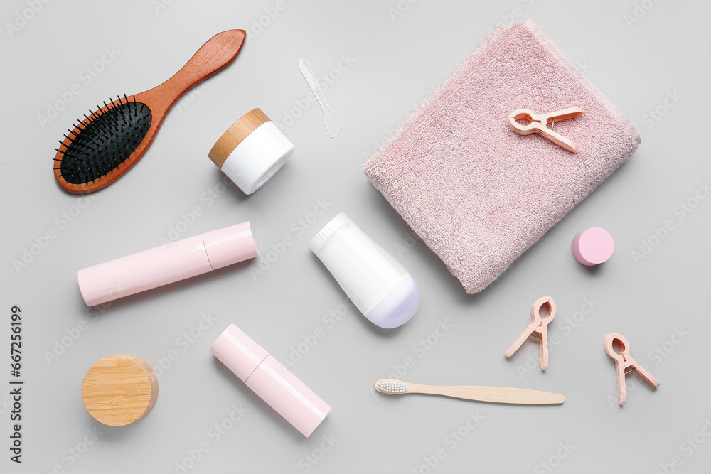 Composition with different cosmetic products and bath supplies on grey background