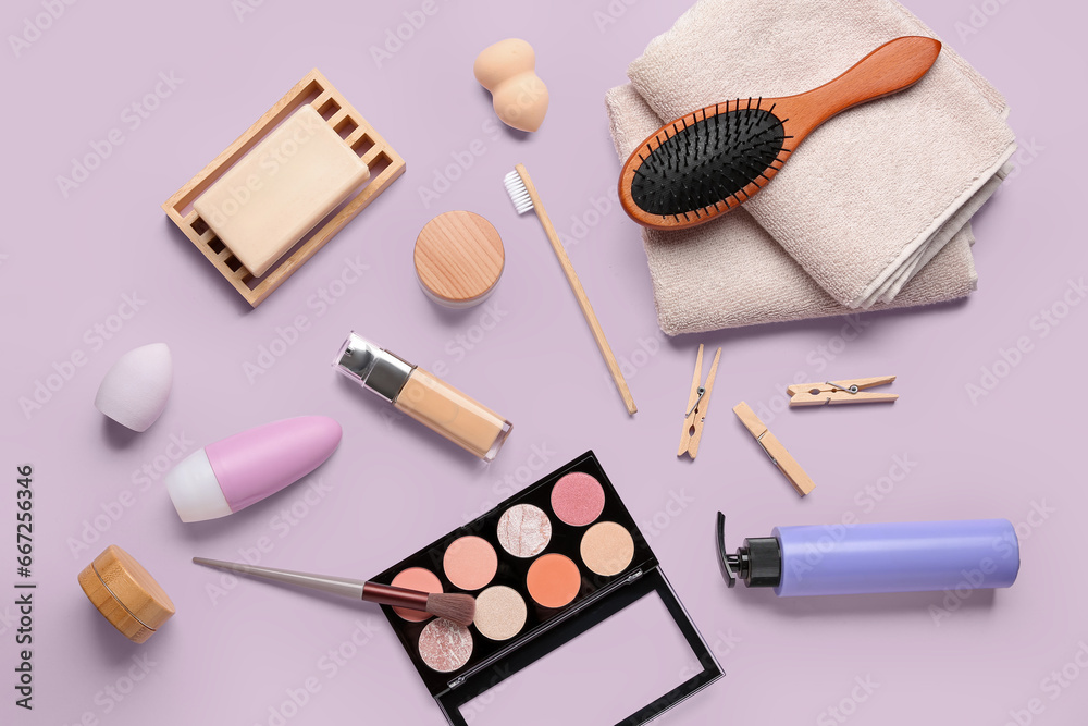 Composition with different cosmetic products and bath supplies on lilac background