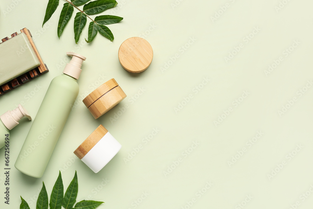 Composition with different cosmetic products and plant leaves on color background