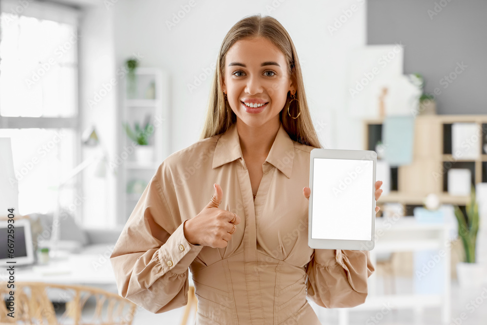 Female interior designer with tablet computer showing thumb-up in office