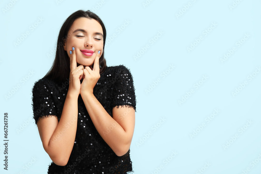 Beautiful young happy woman on blue background