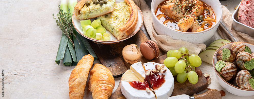 Different kinds of cheeses, baguettes and snacks. French tasting party.