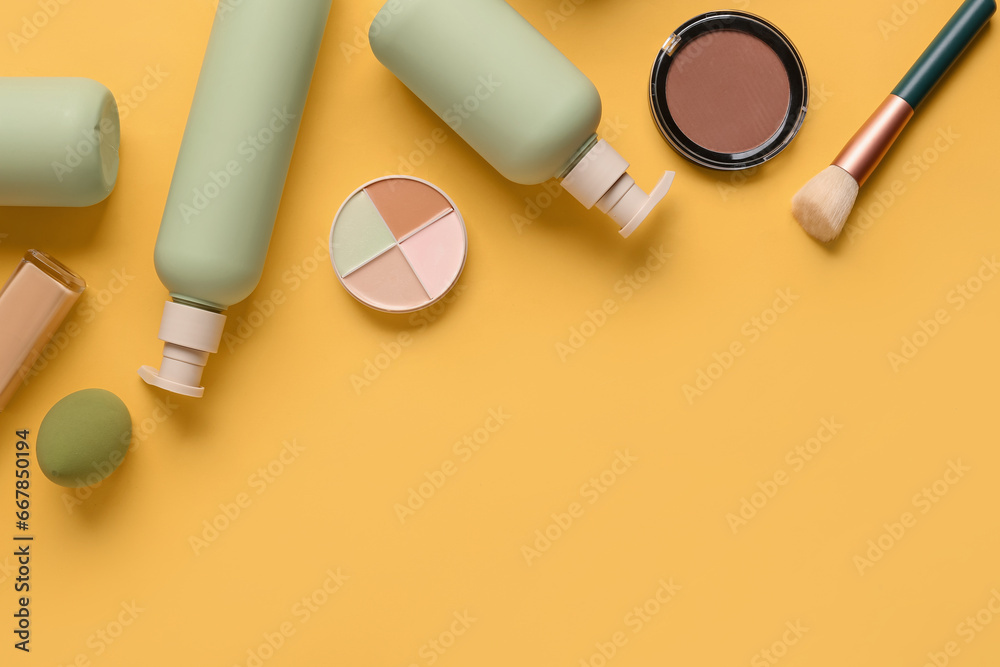 Composition with cosmetic products and makeup accessories on yellow background