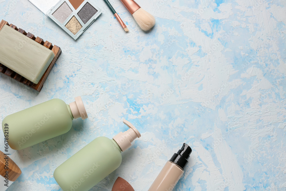 Composition with cosmetic products and makeup brushes on color background