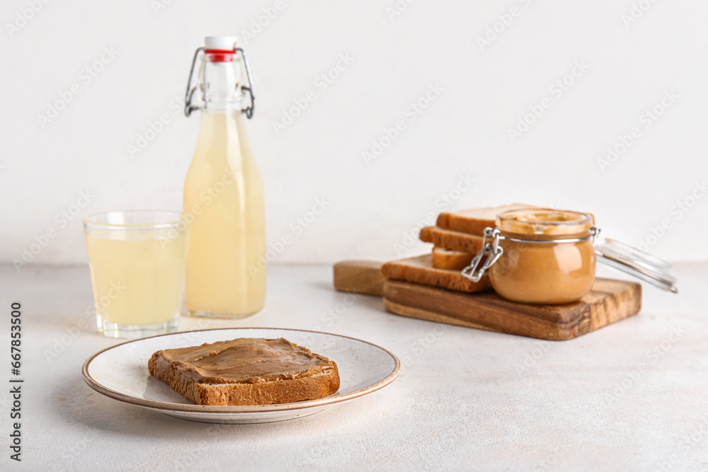 Plate of toast with peanut butter on white background