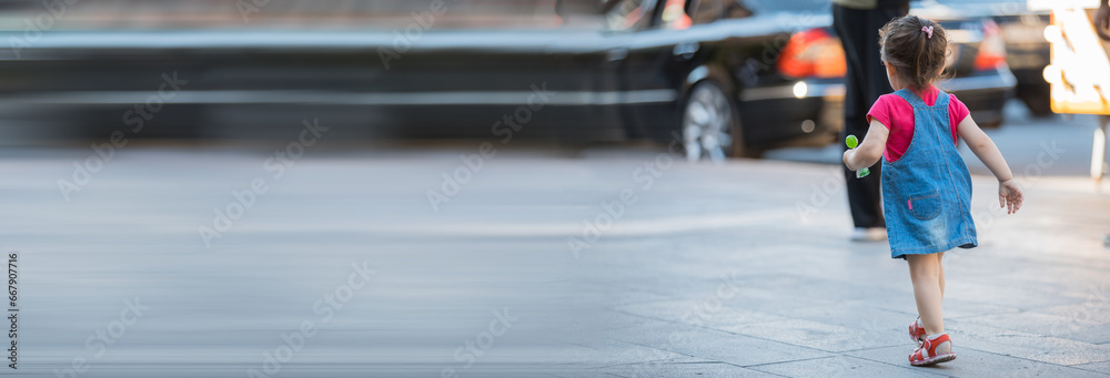 little girl walking in street