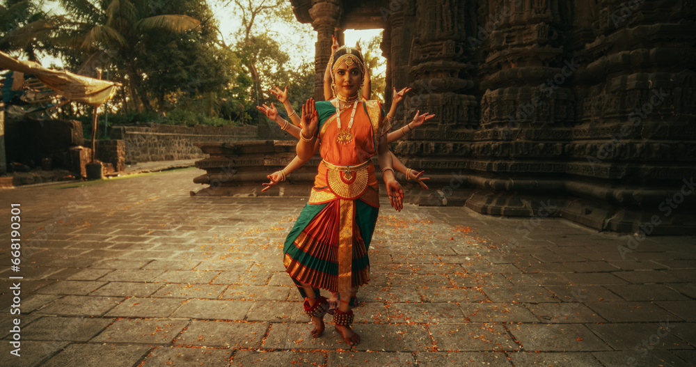 Portrait of Five Women Performing Folk Dance Choreography near Ancient Temple. Indian Women in Colourful Traditional Dresses Beautifully Performing Bharatanatyam Dance of Many Hands