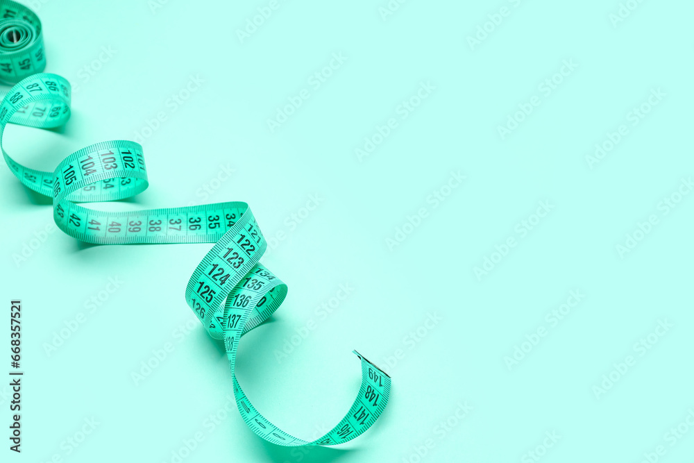 New measuring tape on turquoise background