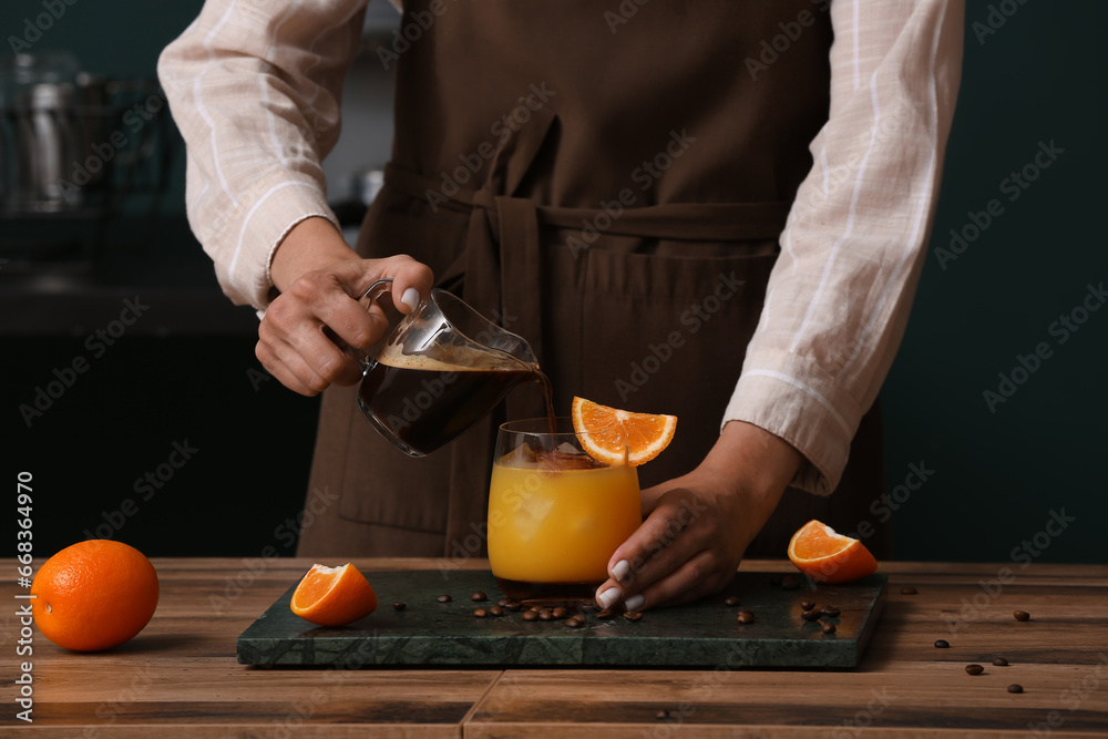 Female barista making coffee drink at table, closeup