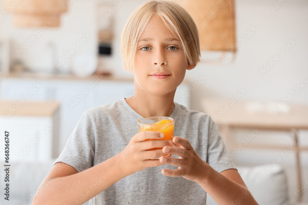 Little boy with glass of juice at home, closeup