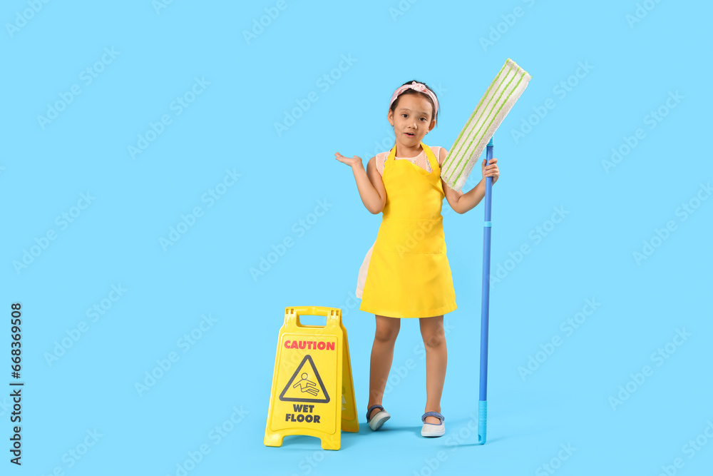 Cute little janitor with mop and caution sign on blue background