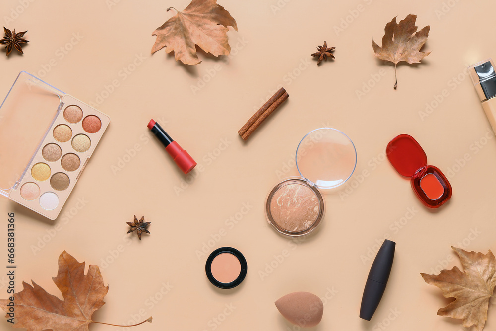 Composition with cosmetic products and autumn leaves on beige background