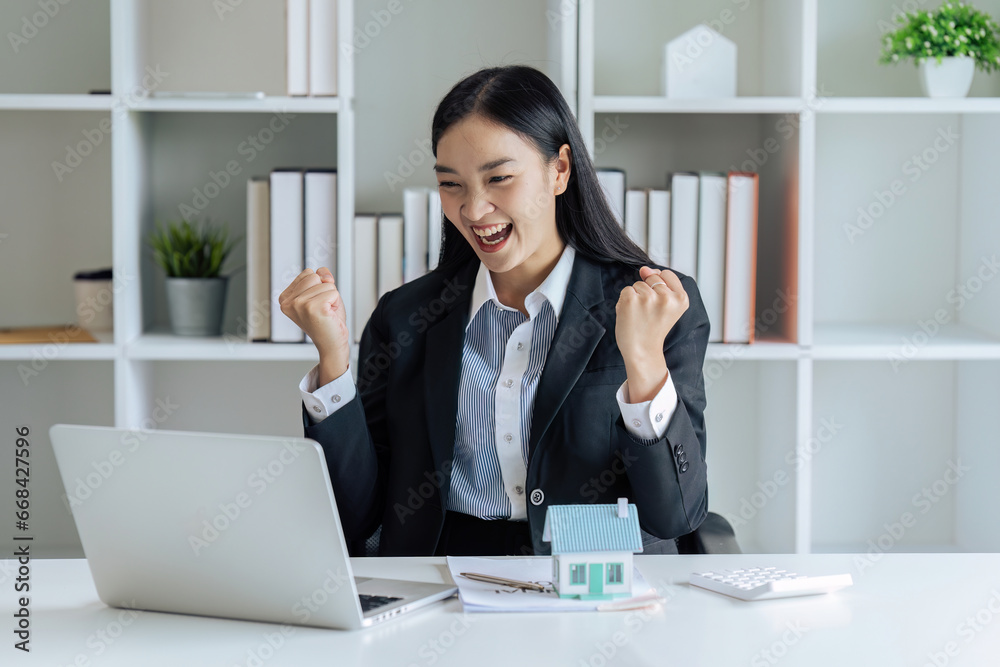 Real estate broker raised hand with happy feeling after posting listing for sale, house can now sold