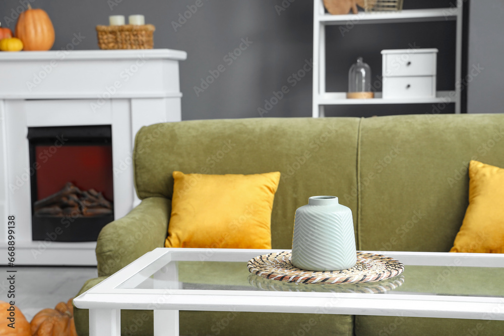 Stylish vase on table in living room