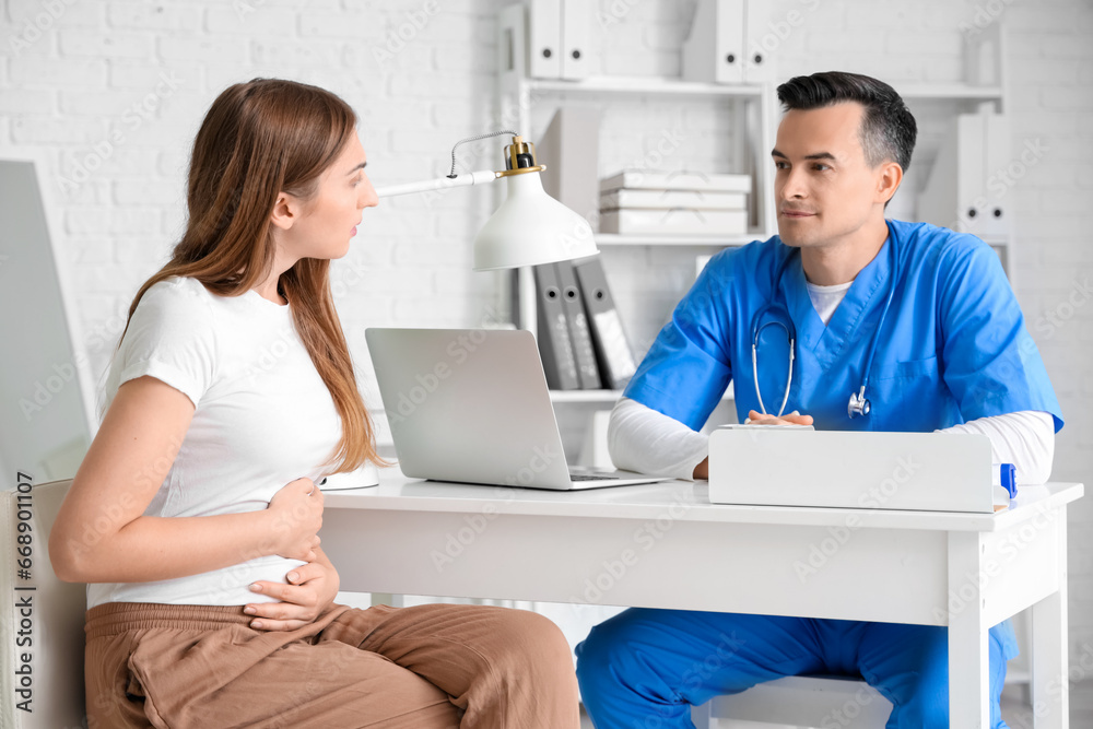 Young pregnant woman visiting doctor in clinic