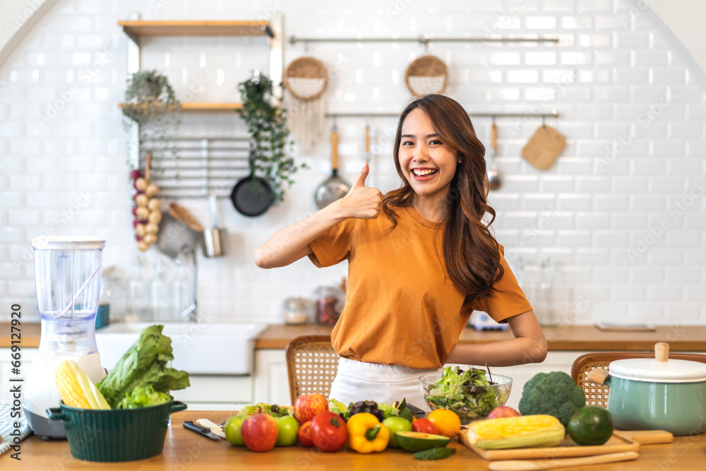 Portrait of beauty body slim healthy asian woman having fun cooking and preparing vegan food healthy eat with fresh vegetable salad, vegetarian on counter in kitchen at home.Diet.Fitness, healthy food