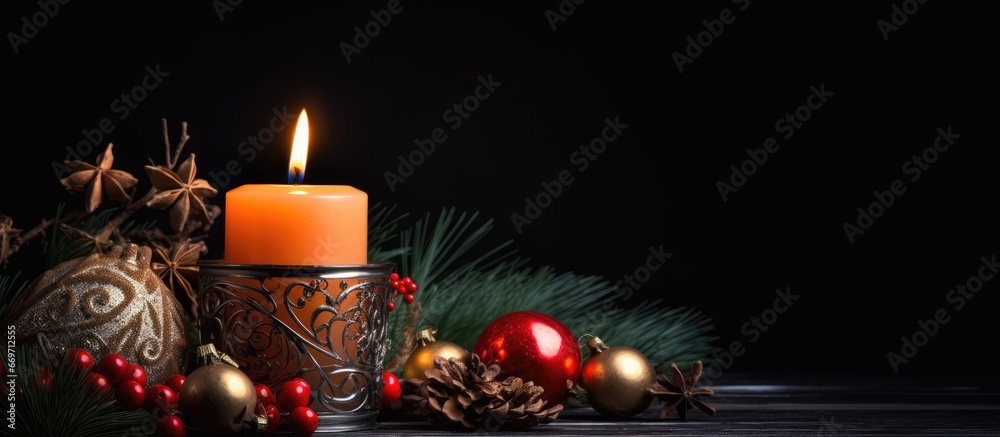 Christmas candle against black backdrop