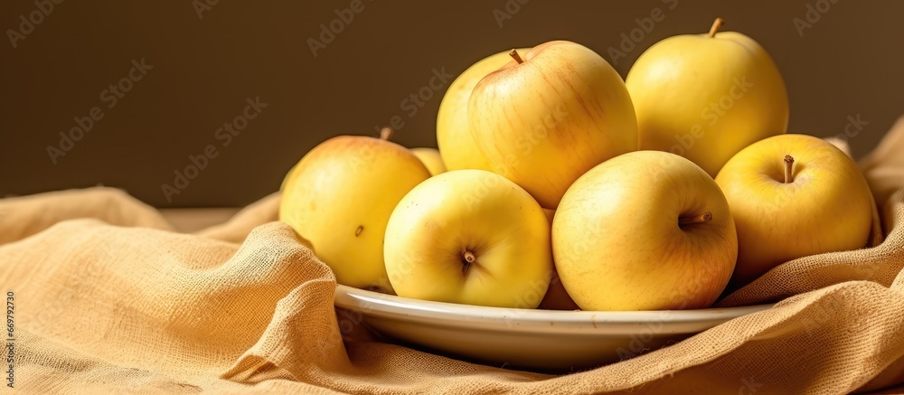 Harvested yellow apples on sandy fabric Ripe fresh juicy healthy fruit