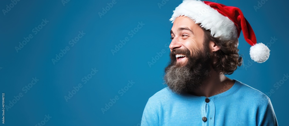 Bearded man by blue backdrop for Christmas theme