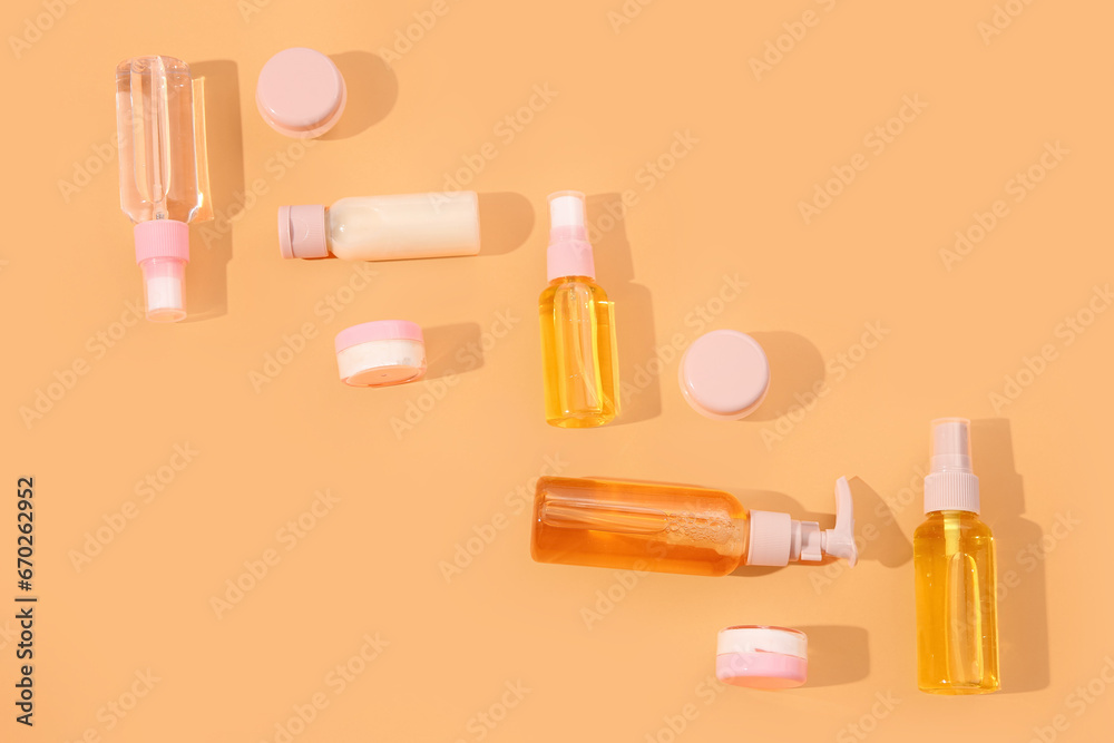 Set of travel cosmetic products on orange background