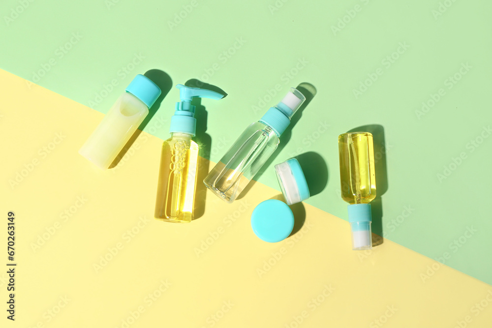 Set of different travel cosmetic products on color background