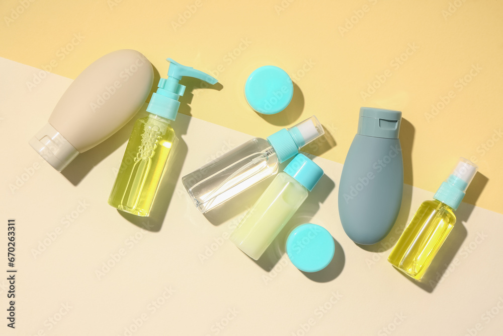 Set of many different travel cosmetic products on color background