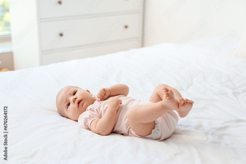 Little cute baby lying on bed at home