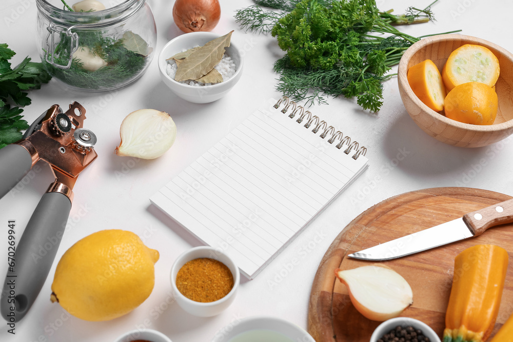 Composition with blank recipe book, fresh vegetables and spices on light background