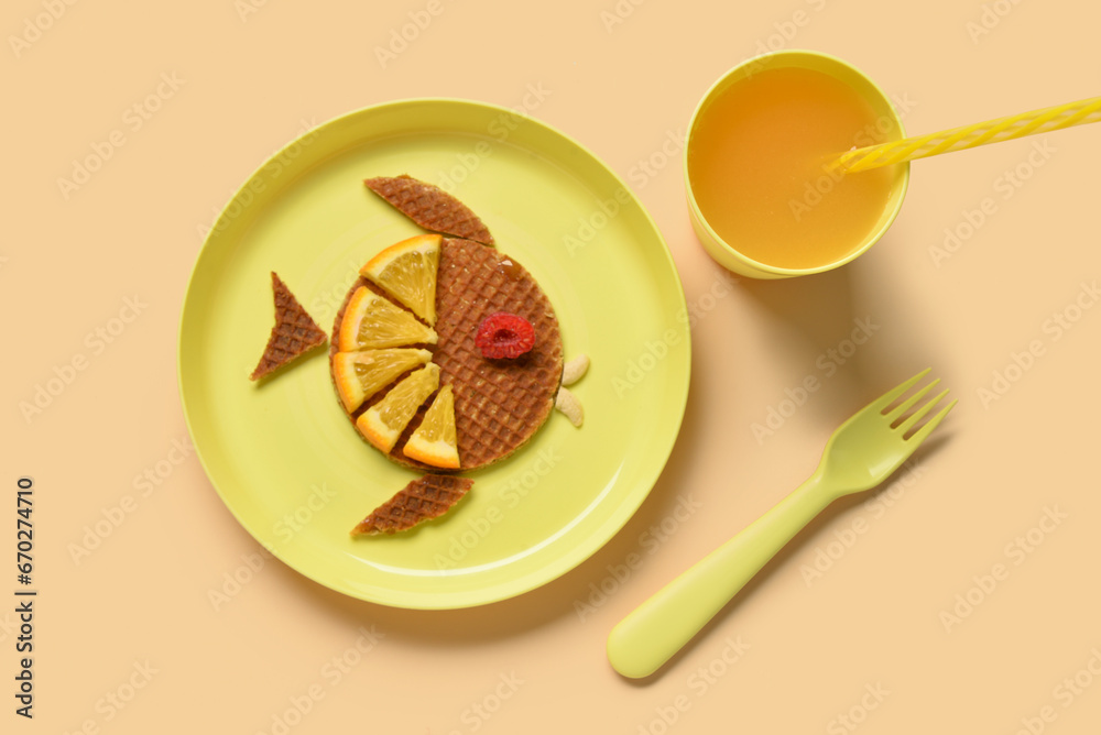 Plate with funny childrens breakfast in shape of fish on beige background