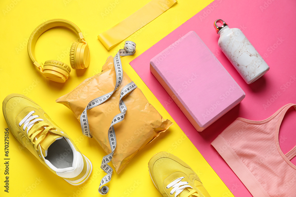 Composition with healthy snack, modern headphones and sports equipment on color background