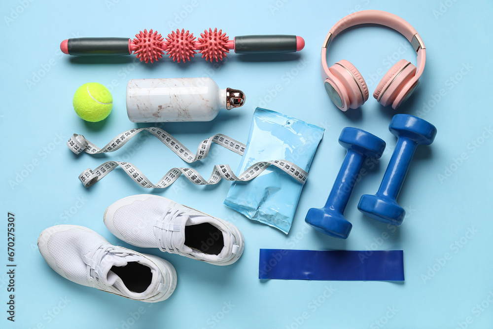 Composition with healthy snack, shoes and sports equipment on color background