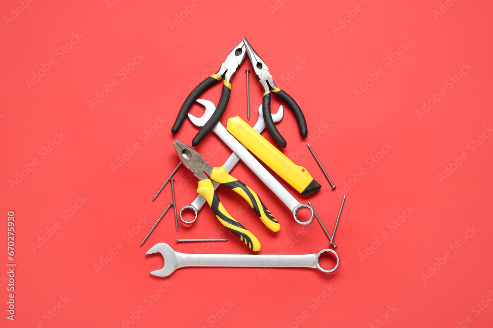 Christmas tree made of repair tools on red background