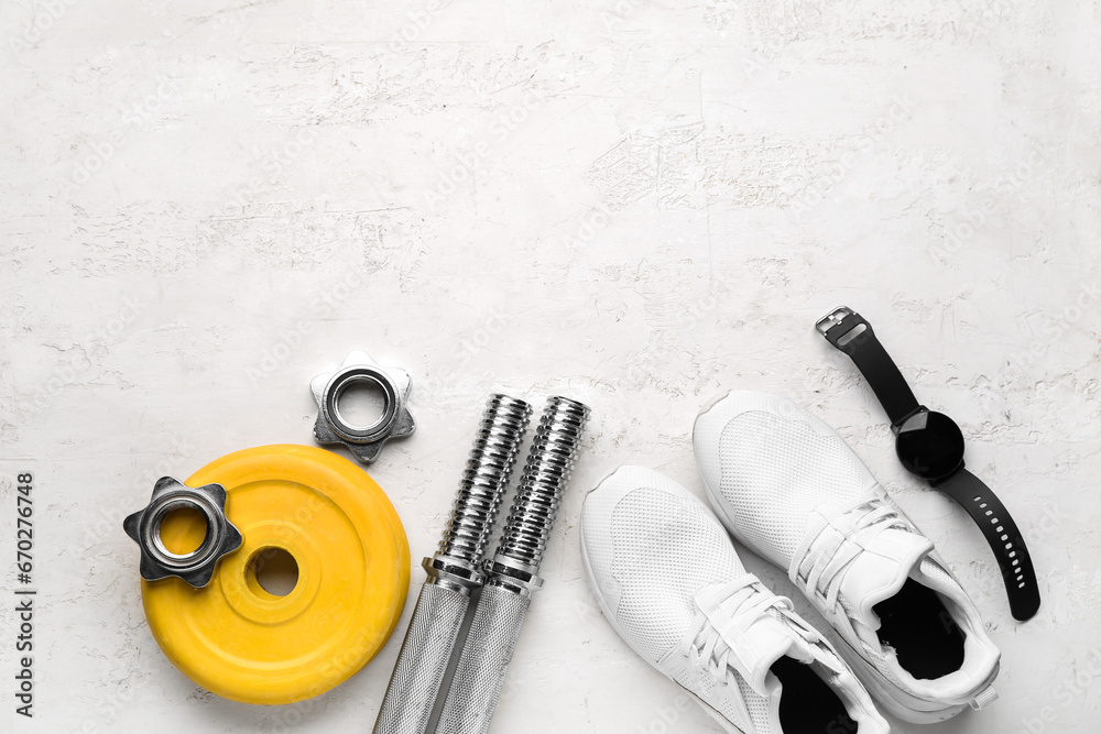 Barbell plates, shoes, watches, grips and clamps on white background